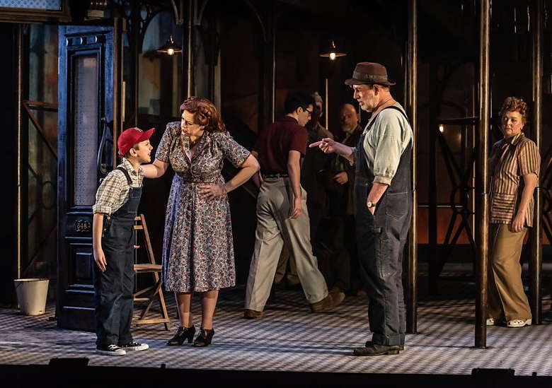 From left to right: Louis Parker as Willie Maurrant, Giselle Allen as Anna, Alex Banfield as Sam Kaplan, Robert Hayward as Frank and Claire Pascoe as Emma Jones in Opera North's 'Street Scene'