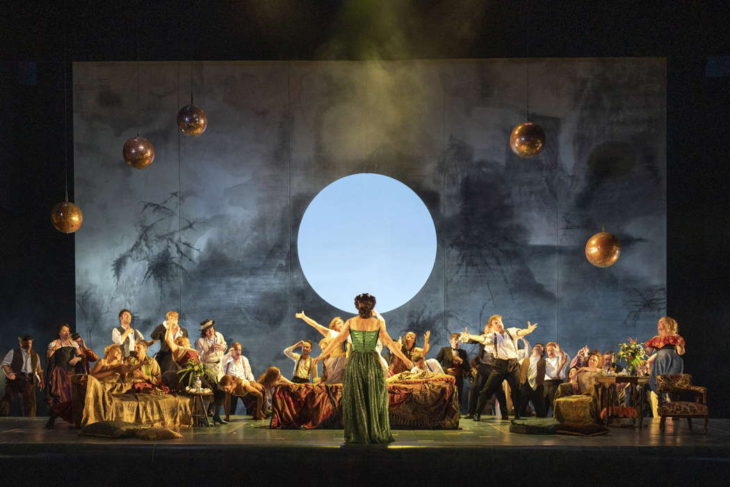 Alison Langer as Violetta Valéry with the Chorus of Opera North in Verdi's 'La traviata'. Photo © 2022 Richard H Smith