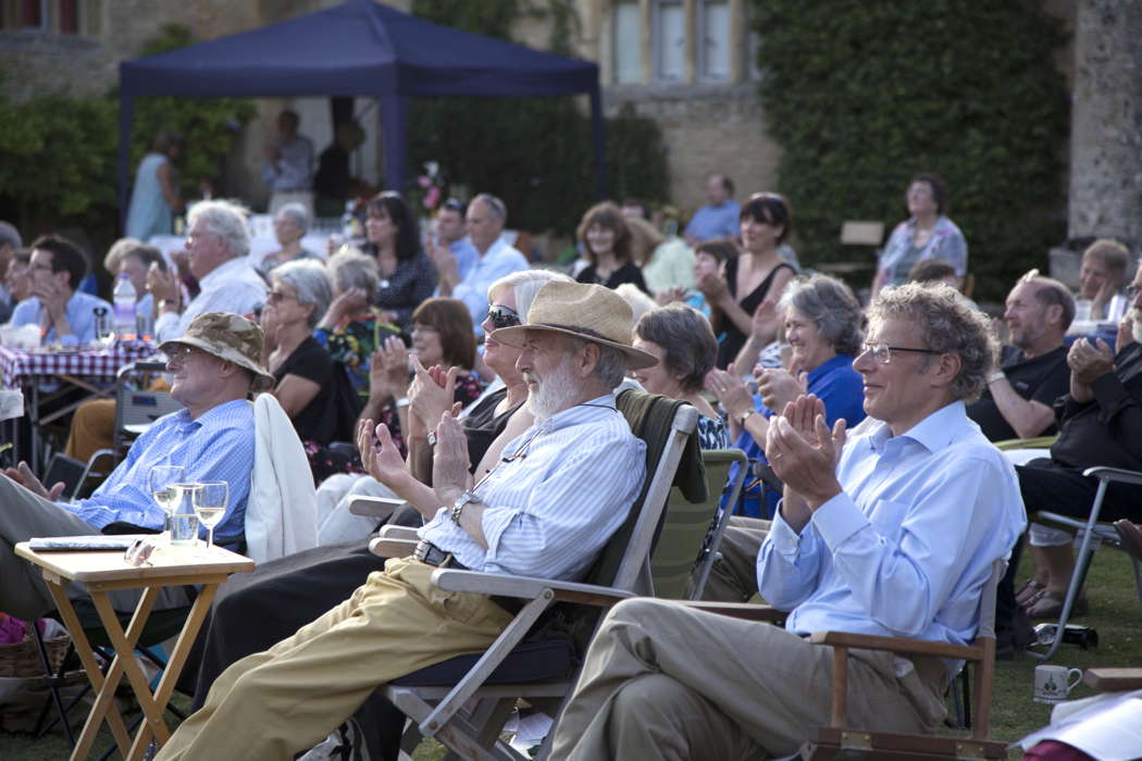 Bampton's Deanery is the ideal venue for summer garden opera. More often than not, the sun actually shines. In the foreground, baritone Henry Herford, a celebrated Bampton aficianado. Photo © 2014 Anthony Hall