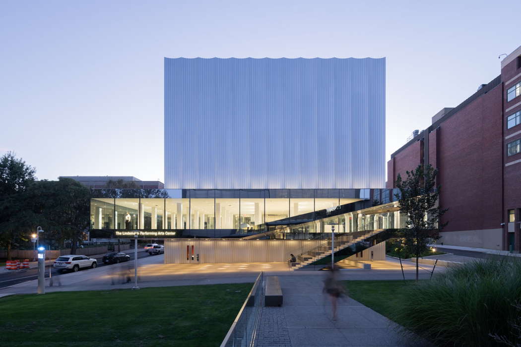 The Lindemann Performing Arts Center at Brown University, designed by REX, showing the elevated lobby which acts as a beacon during eveningtime. Photo © 2021 Iwan Baan
