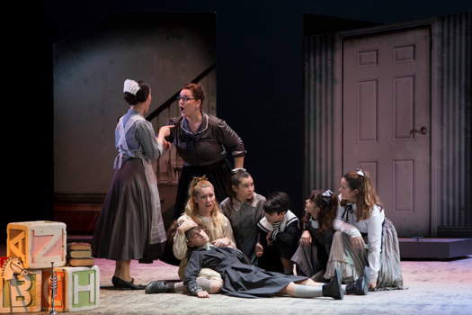 Louise Kong as Ms Rowan, the maid, Irida Dragotti as Mrs Baggot, Lorenzo Gambenedetti as Sam, and the children - Giulia Peverelli, Angelica Splesser, Isabella Mastroemi, Anastasia Spolvieri and Carola Finotti in Teatro dell'Opera di Roma's 'Il Piccolo Spazzacammino'. Photo © 2019 Giulia Guccione