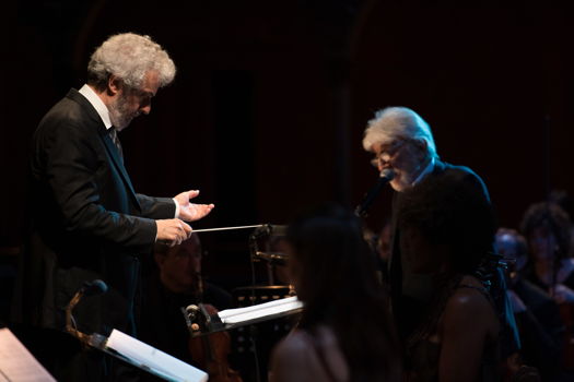 Nicola Piovani (left) conducting his own 'La Pietà' at Teatro dell'Opera di Roma, with narrator Gigi Proietti. Photo © 2019 Fabrizio Sansoni