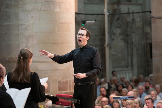 Samuel Hudson, Worcester Cathedral's new Organist and Director of Music, animates the Three Choirs Festival Youth Choir, prising from them all a riveting performance of Karl Jenkins' 'The Armed Man'. Photo © 2019 Michael Whitefoot