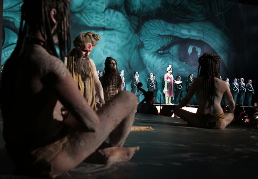 A scene from Rossini's 'Semiramide' at the 2019 ROF featuring Antonino Siragusa and members of the Ventidio Basso Theatre Chorus, with the eyes of the murdered King Nino as backdrop. Photo © 2019 Studio Amati Bacciardi