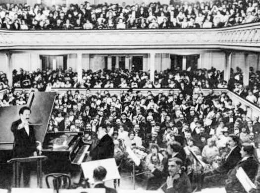Press photograph of Pierre Monteux conducting, with Saint-Saëns at the piano, at Saint-Saëns' planned farewell concert at the Salle Gaveau in Paris on 6 November 1913