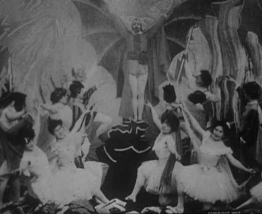 A still from the film 'Faust aux enfers' by George Méliès (1903) - the final scene unfolding in Hell, when Mephisto emerges from the basement and spreads wide bat wings, in the middle of the general jubilation