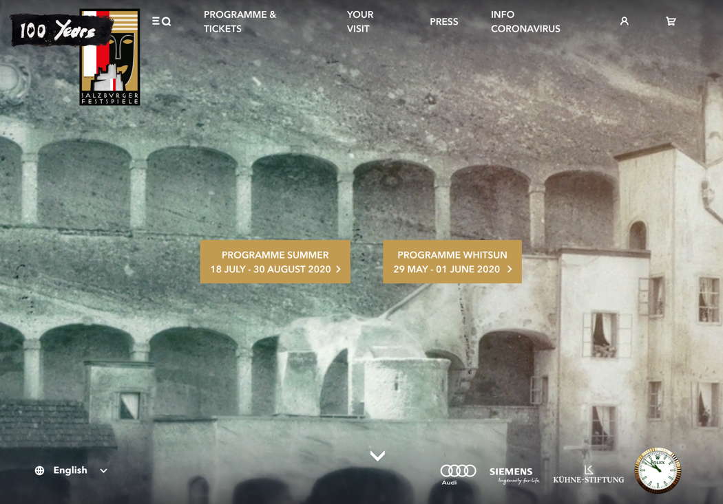 A screenshot of the Salzburg Festival homepage, which shows continuously moving background video. This image shows the Felsenreitschule, the former riding school which is now a performance venue.