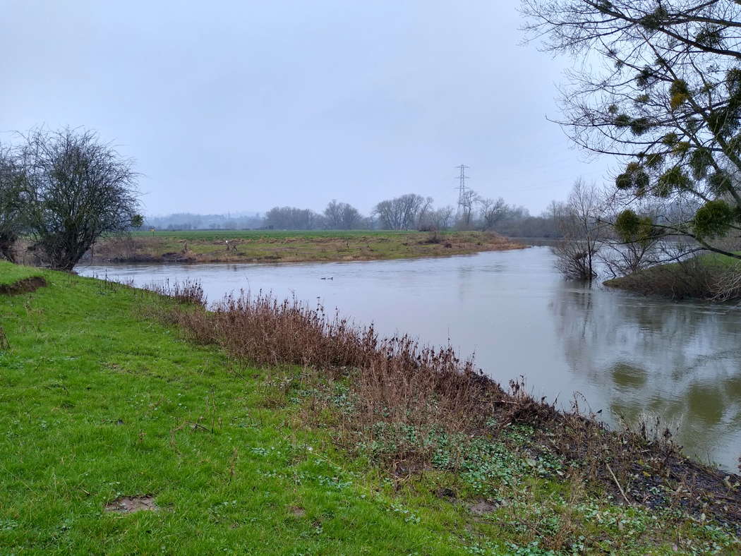 The point at which the River Lugg (bottom right) flows into the River Wye, as the Wye turns a corner, near Mordiford in Herefordshire, UK. Photo © 2022 Keith Bramich