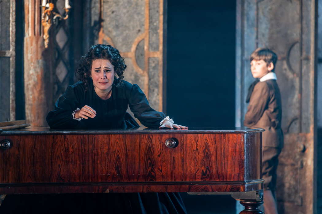 The grand piano brings little comfort. Verity Wingate as the escalatingly obsessive Governess and Miles (Ben Fletcher) in 'The Turn of the Screw'. Photo © 2022 Julian Guidera