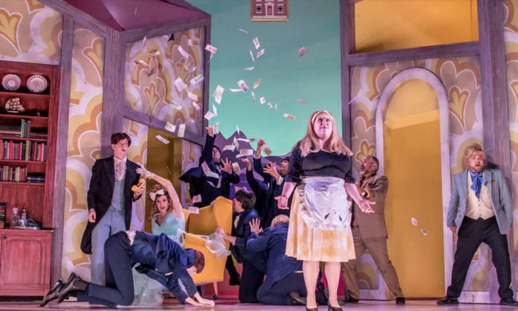 Rossini's 'La Cenerentola' at Nevill Holt Opera - Angelina-Cinderella (Grace Durham) with a typical shambles behind her - left, Malachy Frame as the disguised Dandini, and right, Aaron Godfrey-Mayes (the real Prince, Don Ramiro). Photo © 2023 Genevieve Girling
