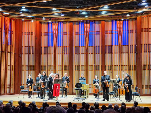 Rose Lombardo (in red) with Edo de Waart (immediately to her left) and members of the San Diego Symphony Orchestra at the Conrad in La Jolla on 9 February 2024. Photo © 2024 Ron Bierman