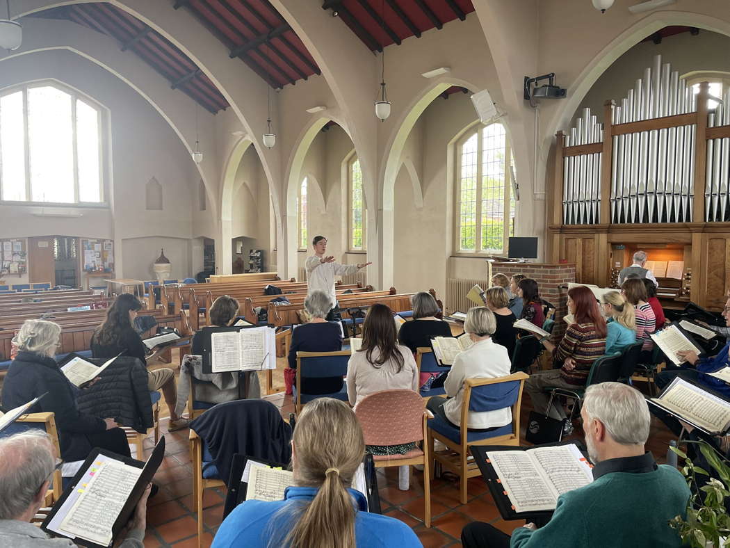 The Sitwell Singers rehearsing at St Nicholas' Church, Derby on 20 April 2024 for the reviewed concert, with Dexter Drown conducting and Tom Corfield at the organ