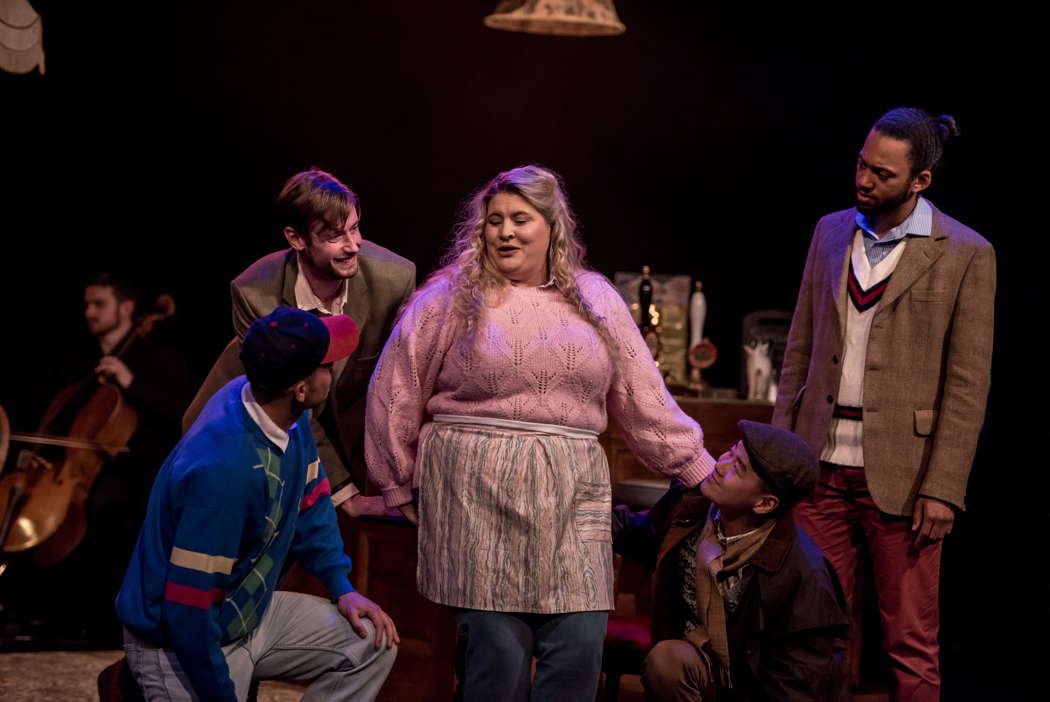 From left to right: cellist Harvey Kelly, Hamish Garrity, James Connolly, Elizabeth Findon as Mrs Waters, Yihui Wang and Brennan Alleyne in Ethel Smyth's 'The Boatswain's Mate' at the Buxton Festival. Photo © 2024 Genevieve Girling