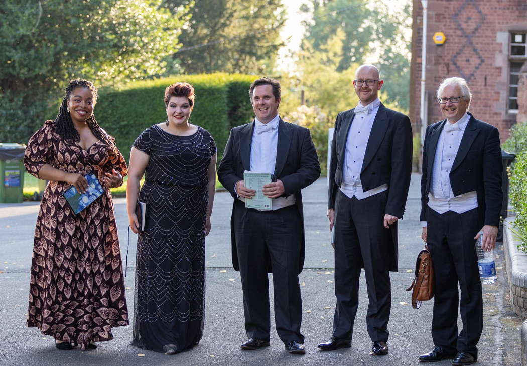 The four Rossini soloists - Francesca Chiejena, Claire Barnett-Jones, Nicholas Mulroy and James W Hall - with conductor Geraint Bowen. Photo © 2024 Dale Hodgetts