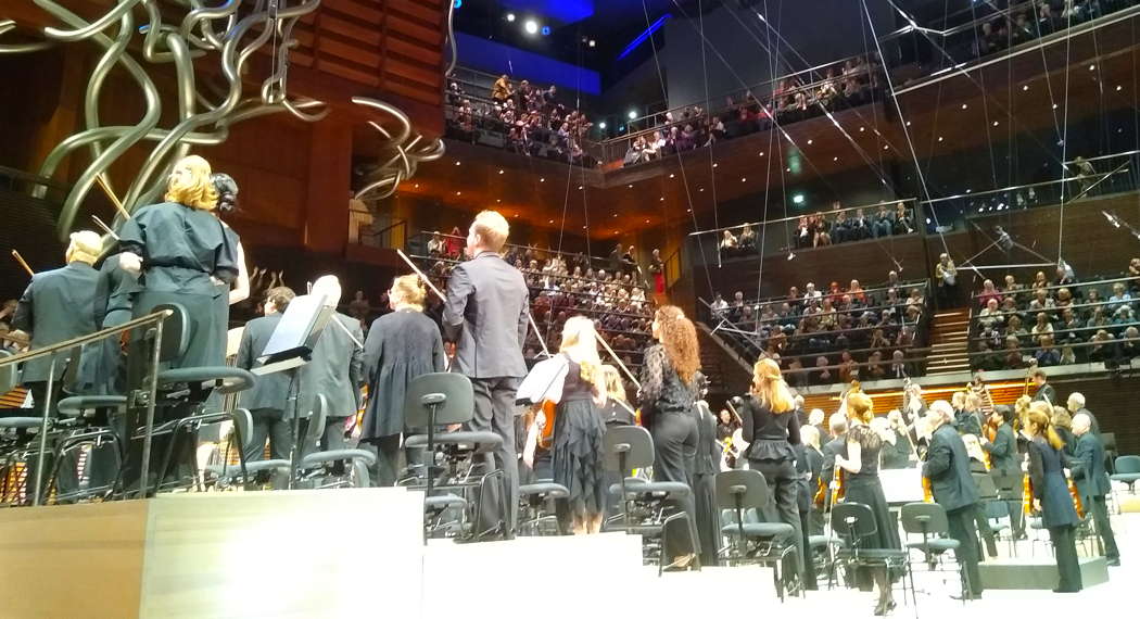 Conductor Elim Chan and the entire Finnish Radio Symphony Orchestra turn through 180 degrees to bow to the audience behind them. Photo © 2024 Keith Bramich