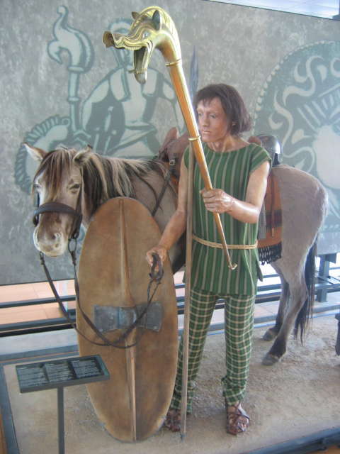 A French museum display of a model carrying a carnyx