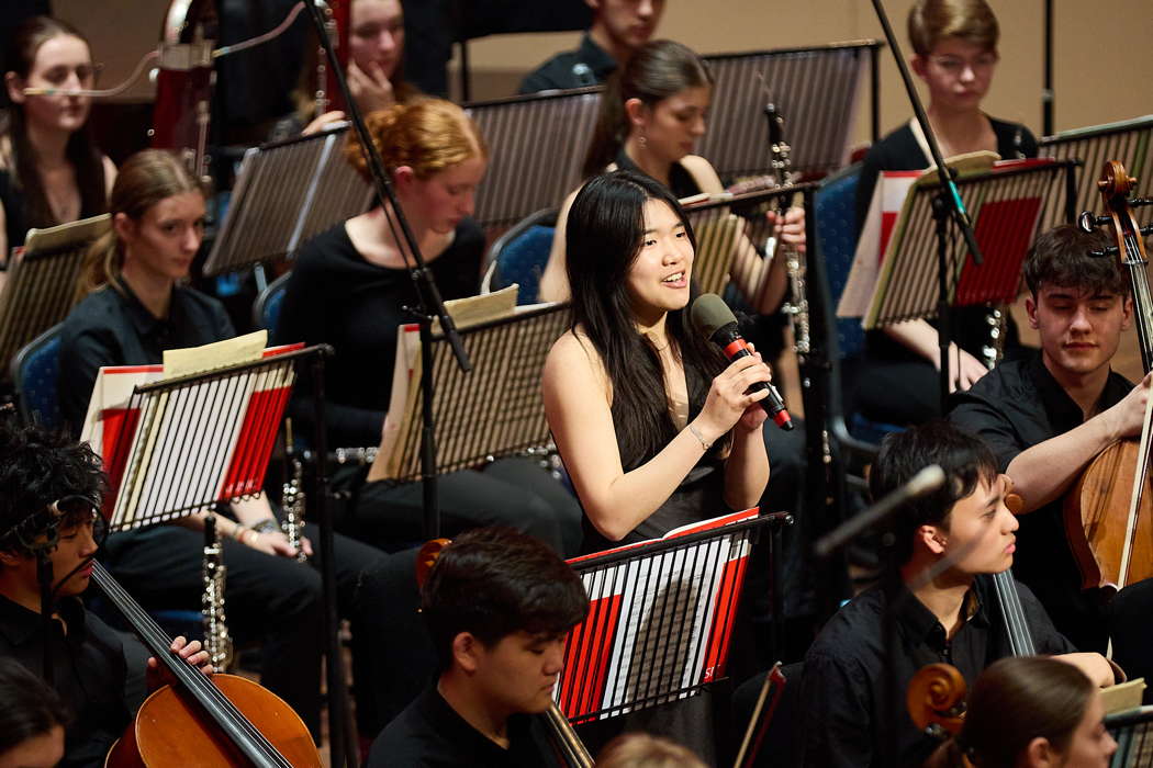 A National Youth Orchestra of Great Britain member speaks to the audience