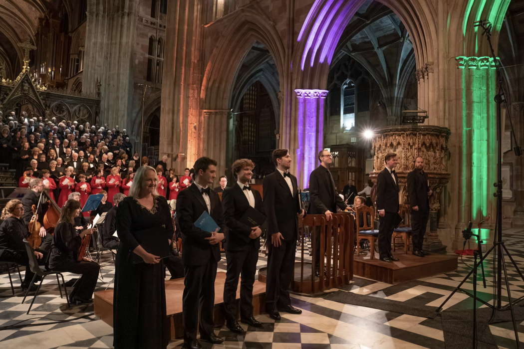 Worcester Festival Choral Society and Meridian Sinfonia (rear) with (front, from left to right): Miriam Allan, Tom Lilburn, Ruairi Bowen, Richard Bannan, Samuel Hudson, Sebastian Hill and David Shipley. Photo © 2025 Michael Whitefoot